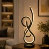 Modern black sculptural LED table lamp with warm white light