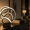 Modern black LED loop table lamp with warm ambient light