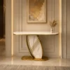 Luxury gold console table with white marble-look top and sculptural base
