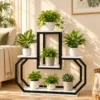 Black geometric metal plant stand with white marble-look shelves